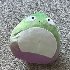 Green and White Dinosaur Squishmellow Toy with Purple Base